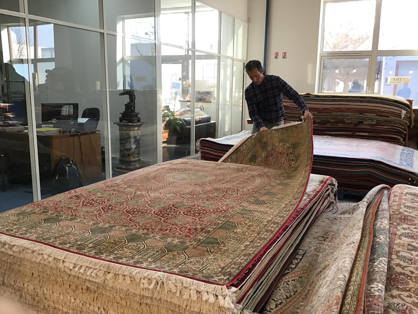 Homme pliant des tapis orientaux.